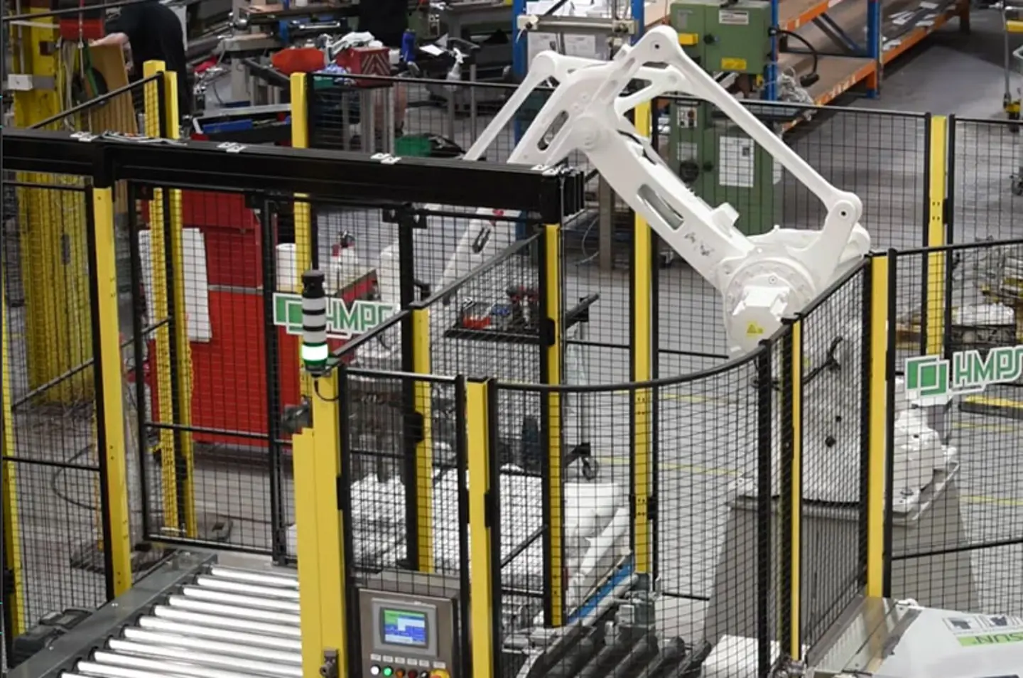 Palletizzatore robotico ad alta velocità che impila scatole su pallet all’interno di un’area protetta