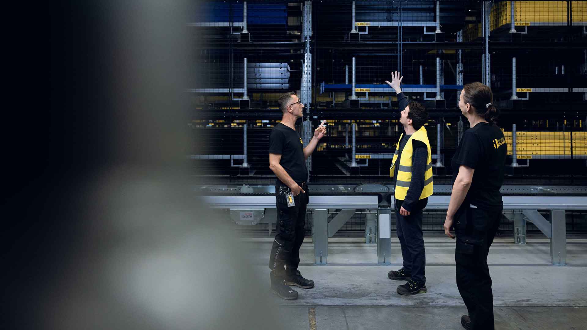Two men pointing at about warehouse storage and mesh panels